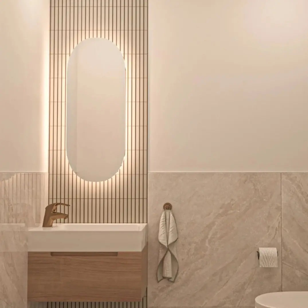 The Sevilla Mosaic Tiles, Original KitKat design in a Cafe Latte, with a size of 20x145mm installed on a feature wall within a bathroom with a vanity and sink unit and a mirror mounted on top.