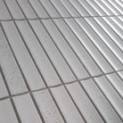 The sevilla mosaic tiles, original kitkat design, in a stracciatella. Measuring 20x145mm. image is on a slight side view on an angle.